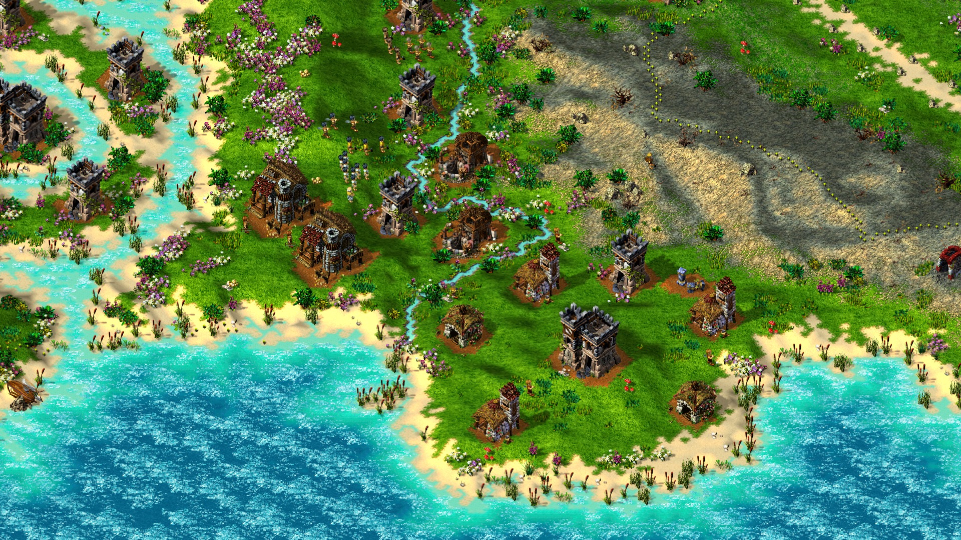 Küstenlandschaft mit türkisem Meer, Sandstränden und einer Siedlung auf einer Landzunge